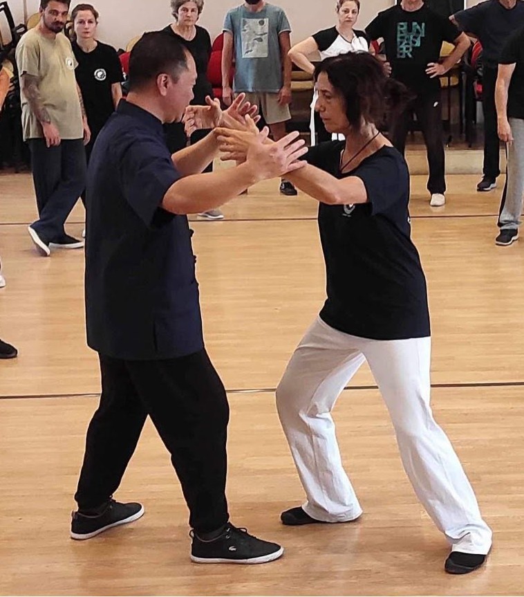 Alex Dong testing the tai chi arm position under pressure.