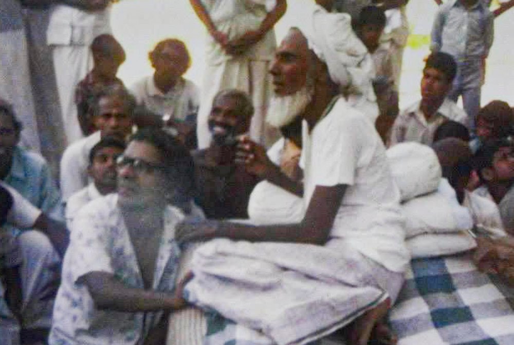 Bawa Muhaiyaddeen seated among students while giving a spiritual teaching in Sri Lanka.