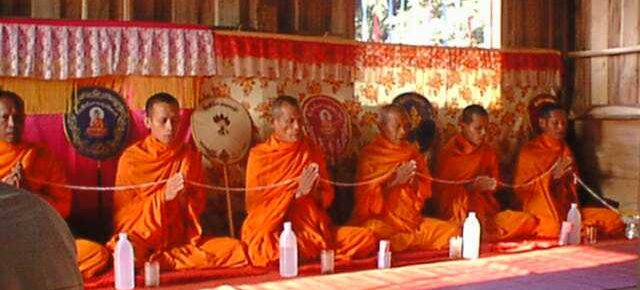 Buddhist monks chanting together in a monastery, illustrating collective meditation, shared practice, and the cultivation of attention through community.