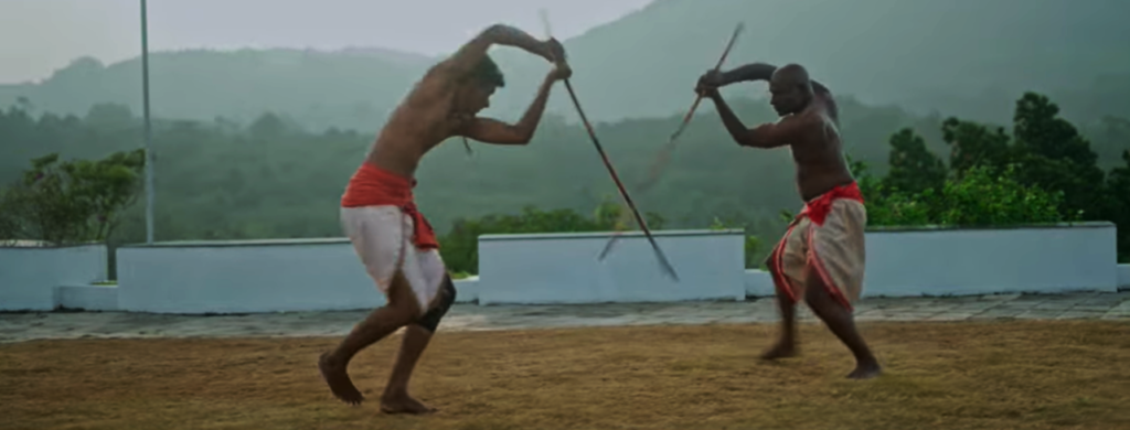 Guru Yogi Shivan and a student practicing Vadi Payattu staff training in the traditional martial art of Kalaripayattu in Kerala, India.