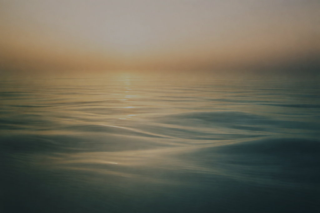 Mist drifting across calm water at dawn, symbolizing reflection, healing, stillness, and inner awareness.