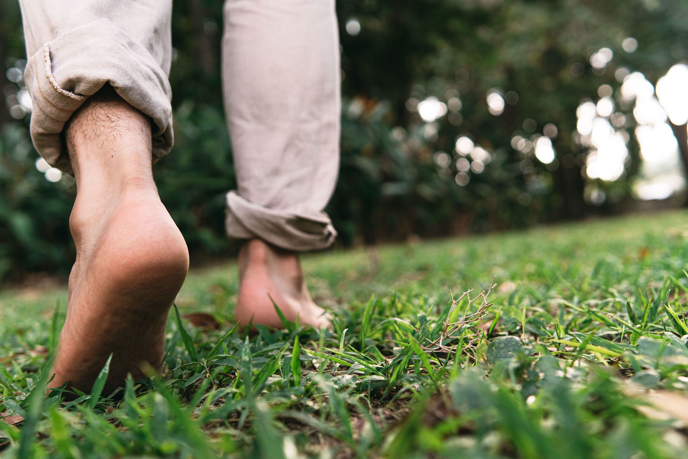 Bare feet standing on grass representing the many pathways into Inner Life through embodiment, practice, wisdom traditions, and consciousness.