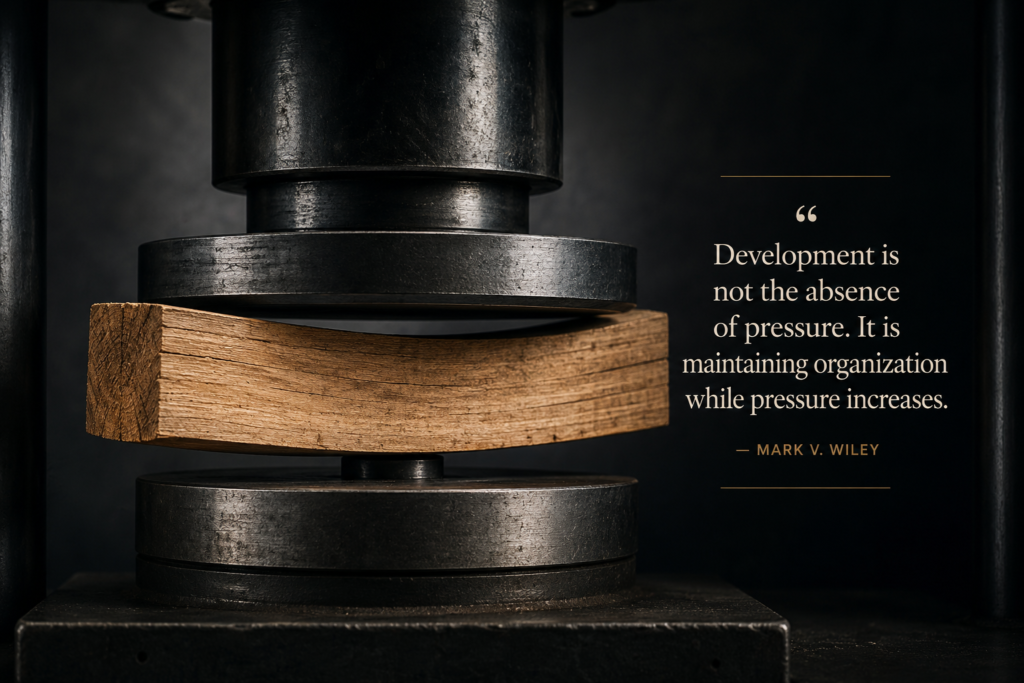 Wooden beam under compression testing, bending under pressure while maintaining structural integrity and resisting failure.