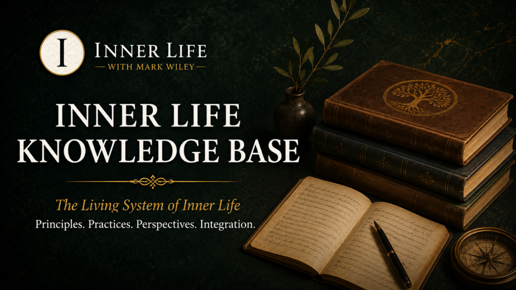 Books and an open journal overlooking a mountain landscape at sunrise, symbolizing the Inner Life Knowledge Base and the exploration of embodied human development through direct experience.