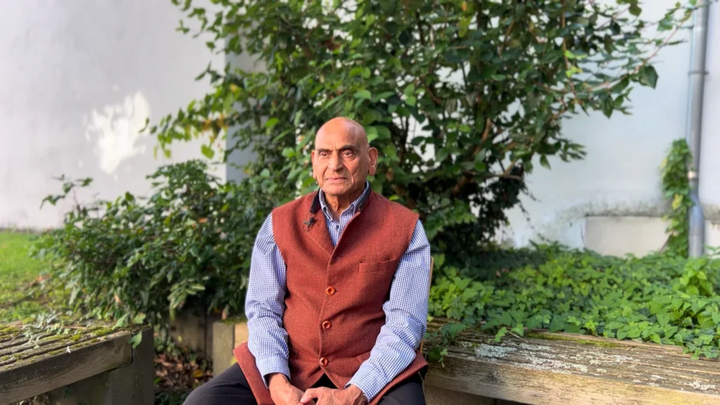 Dr. Ravi Ravindra seated outdoors in quiet contemplation, reflecting on consciousness, spiritual transformation, self-study, and the world's wisdom traditions of spiritual transformation