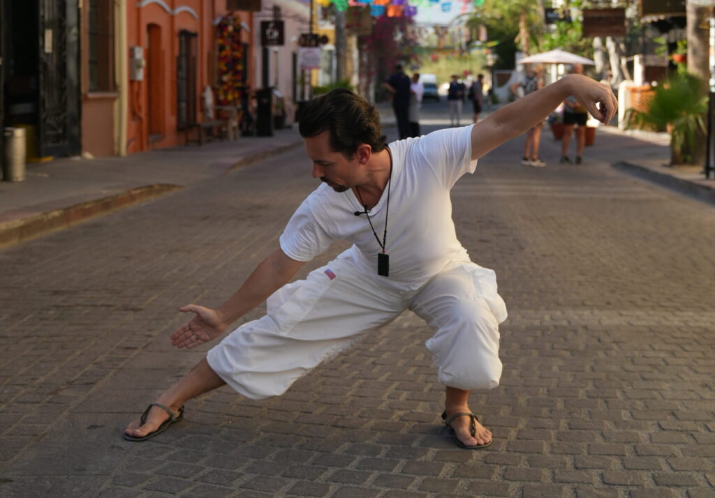 Fabrice Piché demonstrating an authentic Taiji Qigong Shibashi posture with relaxed alignment, coordinated breath, and embodied awareness.