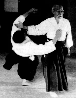Morihei Ueshiba demonstrating Aikido, illustrating organized presence and grace under pressure through embodied awareness.