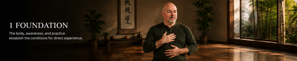 Mark Wiley practicing embodied awareness with one hand on his chest and the other on his abdomen, illustrating how body, awareness, and practice establish the foundation for direct experience.