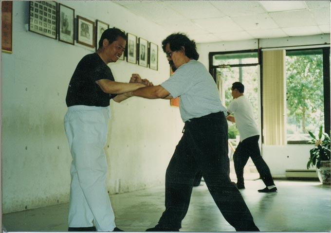 René Navarro practicing traditional Tai Chi push hands with Grandmaster Gin Soon Chu, demonstrating lineage transmission, sensitivity, and embodied learning.
