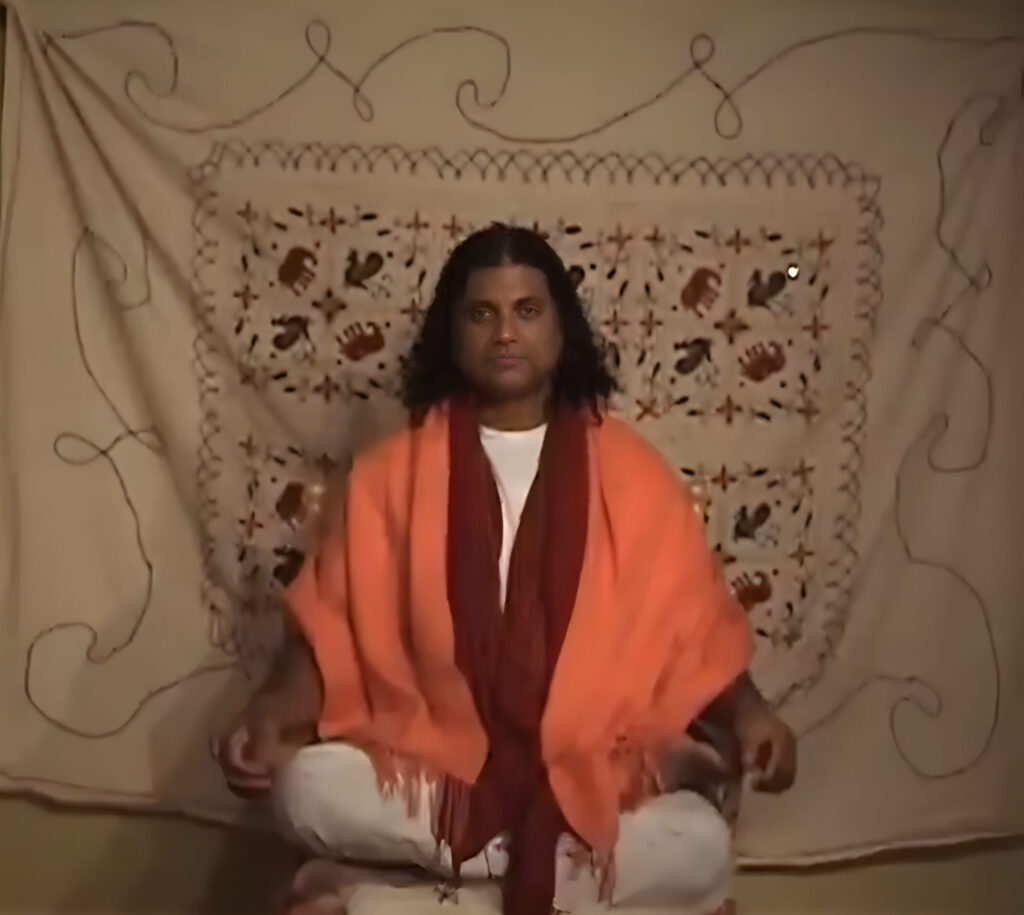 Swami Kripananda demonstrating seated meditation and breath awareness during yoga practice.