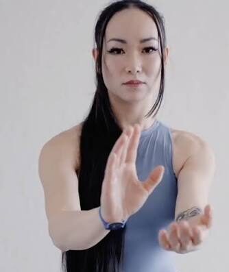 Fabrice Piché demonstrating an authentic Taiji Qigong Shibashi movement while explaining how students learn the 18 Movements practice.