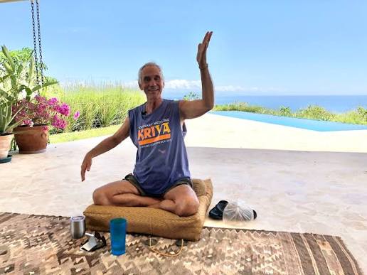 Will Johnson demonstrating embodied meditation and breathing through the whole body while seated in meditation overlooking the Costa Rican coast.