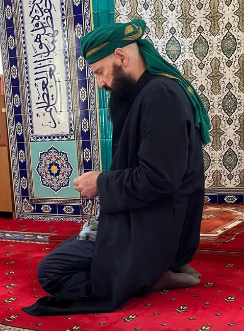Shaykh Burhanuddin Herrmann seated in zikr during Sufi practice