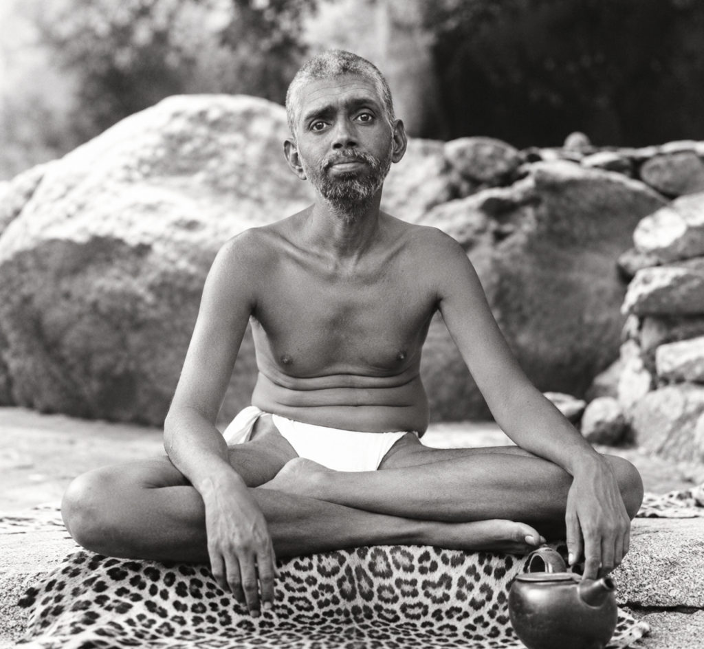 Ramana Maharshi seated in meditation, illustrating his teaching of self-investigation and the question “Who am I?”