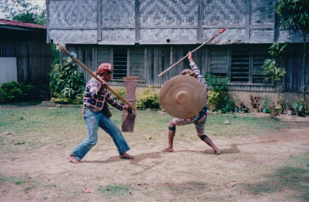 Two members of the Matigsalog Tribe in Mindanao, Philippines, circling one another with spear and shield.